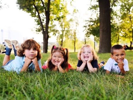 group of preschool children playing in the Park on the grass